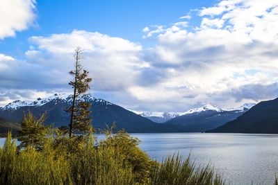 Scenic view of lake and mountains against sky