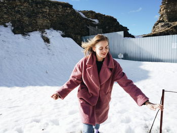 Portrait of smiling woman in snow