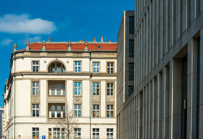 Low angle view of buildings in town against sky