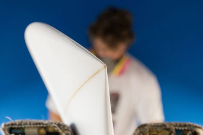 Man with surfboard against clear sky