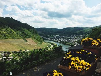 Scenic view of river by mountains against sky