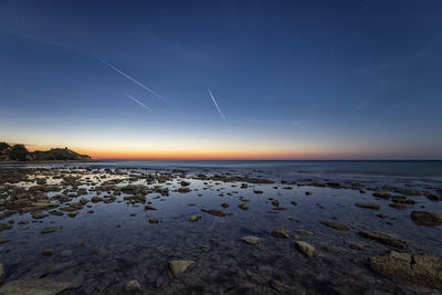 Scenic view of sea against sky at night