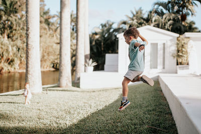 Full length of boy running in park