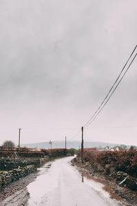 Road by street against sky in city