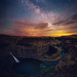 Scenic view of rock formation against sky at sunset