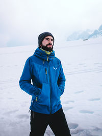 Portrait of young man skiing on snow