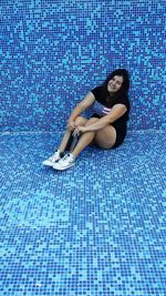 Rear view of a young woman in swimming pool