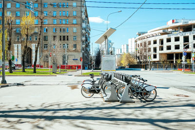 Bicycle on street against buildings in city