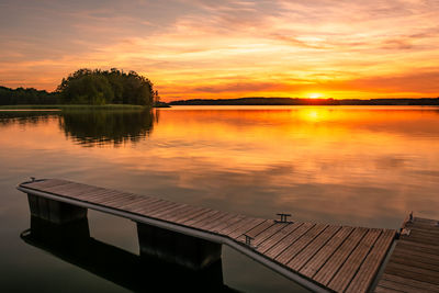 Scenic view of lake against orange sky