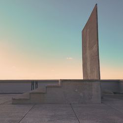 Lifeguard hut against clear sky during sunset