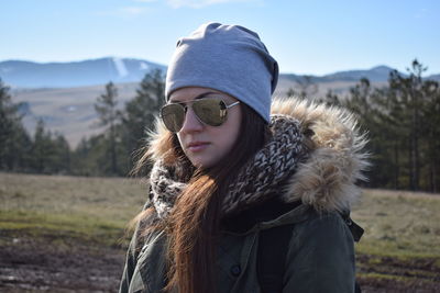 Close-up portrait of young woman wearing sunglasses