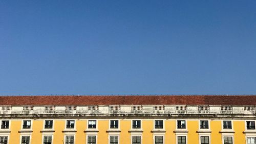 Low angle view of building against clear blue sky