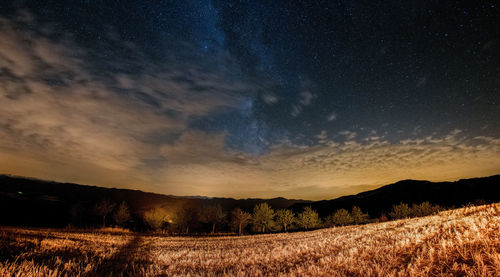 Scenic view of field against sky at night