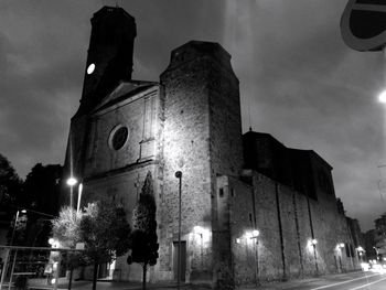 Low angle view of illuminated building against sky at night