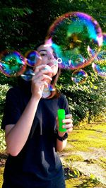 Full length of a beautiful young woman in bubbles