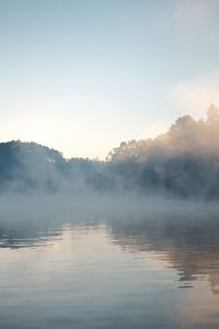 Scenic view of lake against sky at morning