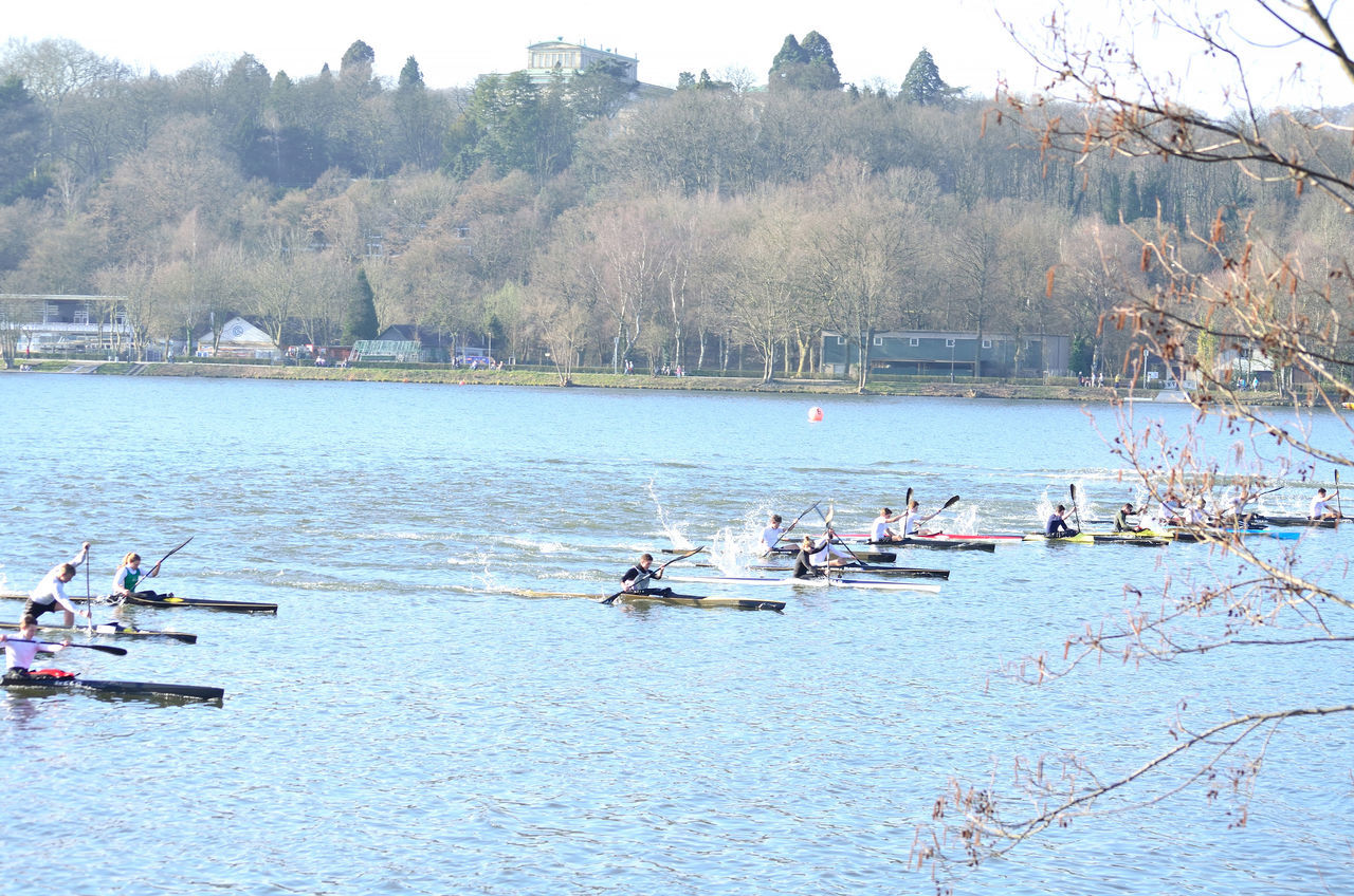 GROUP OF PEOPLE ON BOATS IN LAKE