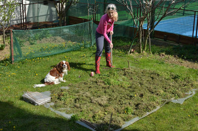 Full length of man with dog in yard