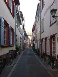 Street amidst houses against sky