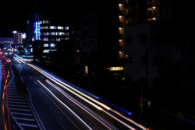 High angle view of light trails on road at night