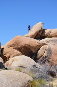 Low angle view of rock formation against clear blue sky