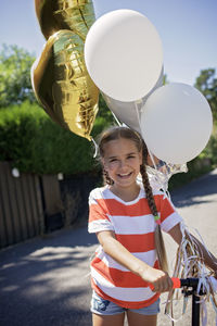 Portrait of cute girl with balloons