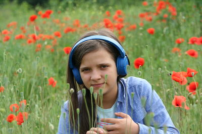 Portrait of happy girl with flowers on plant