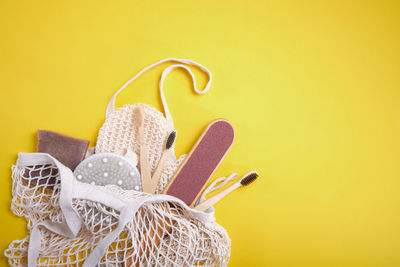 Close-up of wicker basket on yellow wall