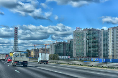 View of city street and buildings against sky