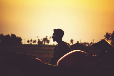 Silhouette man looking away during sunset