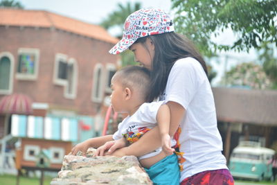 Side view of mother and daughter outdoors