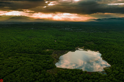 Scenic view of land against sky during sunset