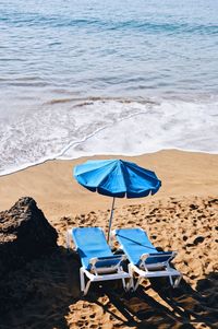 Deck chairs and parasols on beach