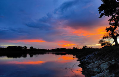 Scenic view of lake against romantic sky at sunset