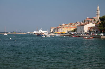 Boats in sea against clear sky