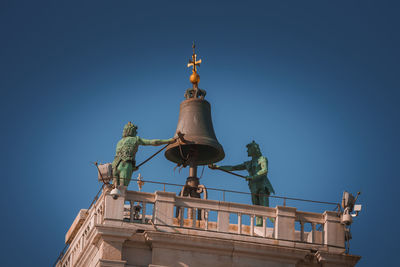 Low angle view of statue against clear blue sky