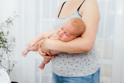 Midsection of mother and daughter at home