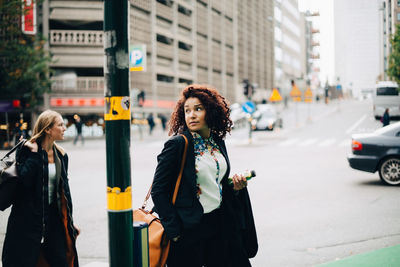 Woman standing on city street