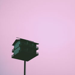 Low angle view of birdhouse against clear sky