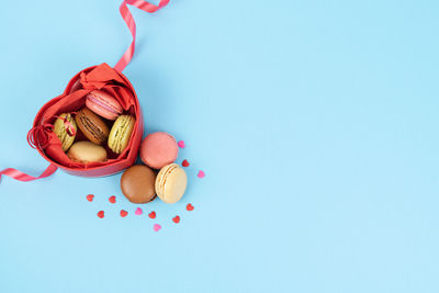 High angle view of multi colored candies against blue background