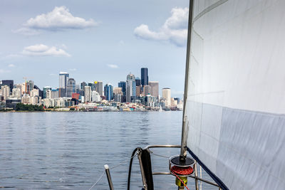 Cropped image of boat in river against buildings