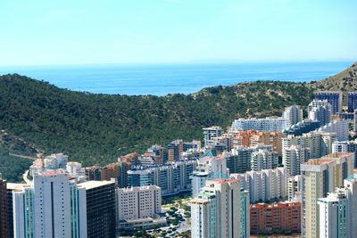 View of cityscape against blue sky