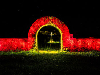 View of illuminated red building at night