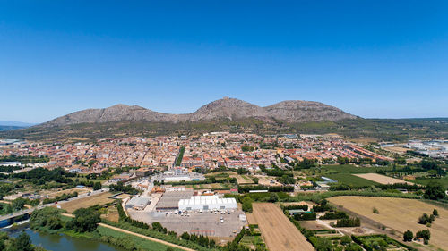 High angle view of townscape against clear blue sky