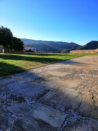 Scenic view of field against clear blue sky