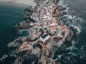 High angle view of buildings by sea