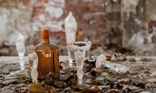 Close-up of glass bottles on wall