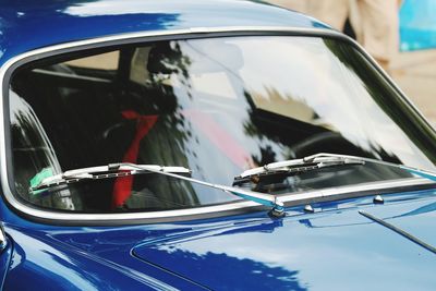 Close-up of blue car on side-view mirror