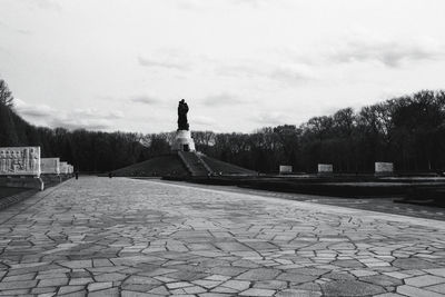 Woman sitting on stone wall