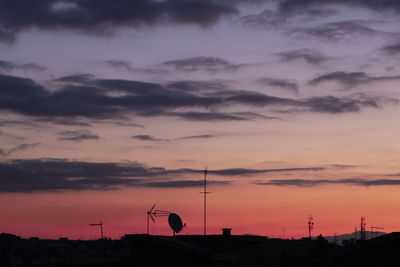 Silhouette of building against dramatic sky during sunset